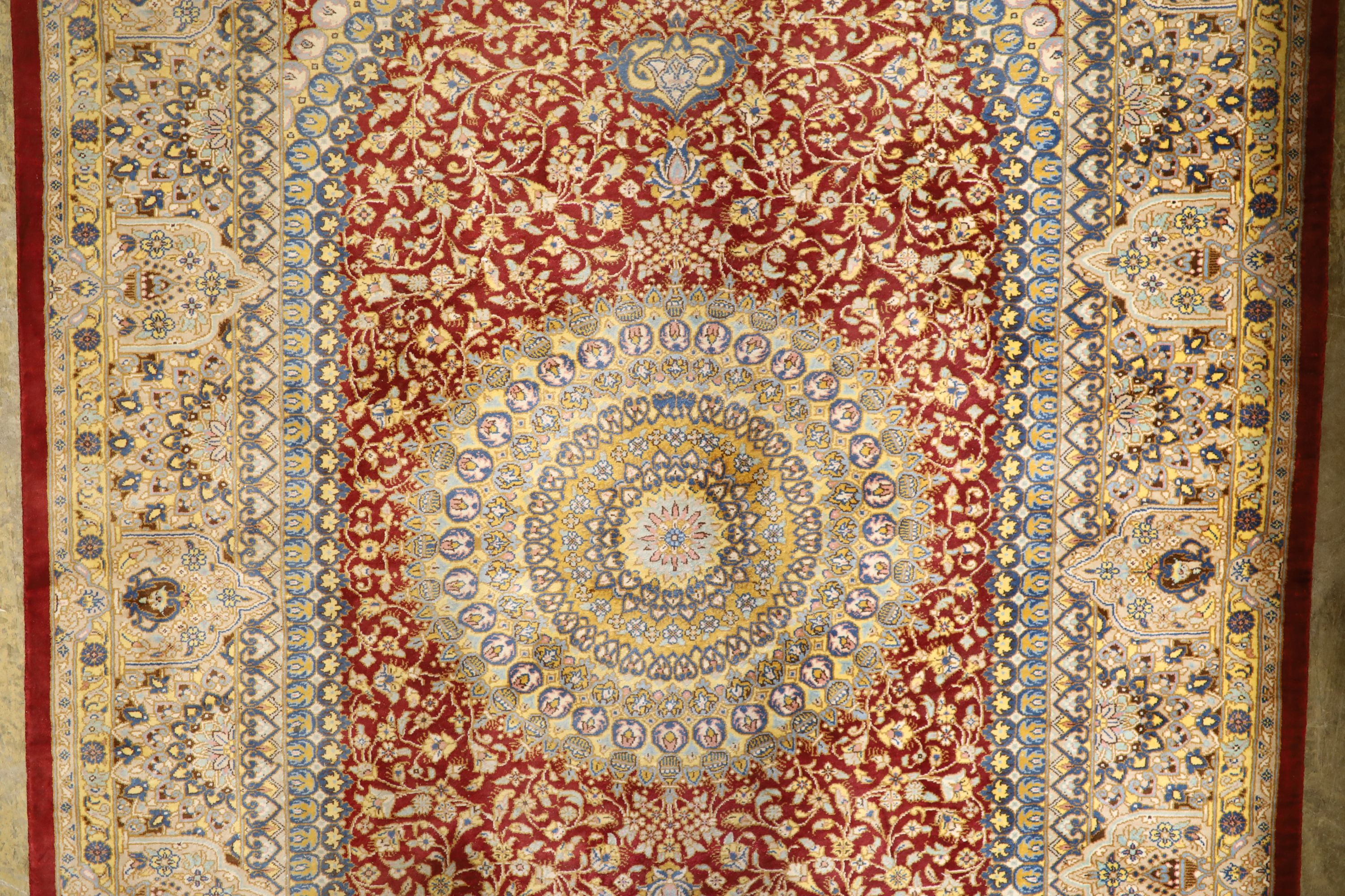 A Persian part red ground silk multi-floral patterned rug, 110 x 80cm